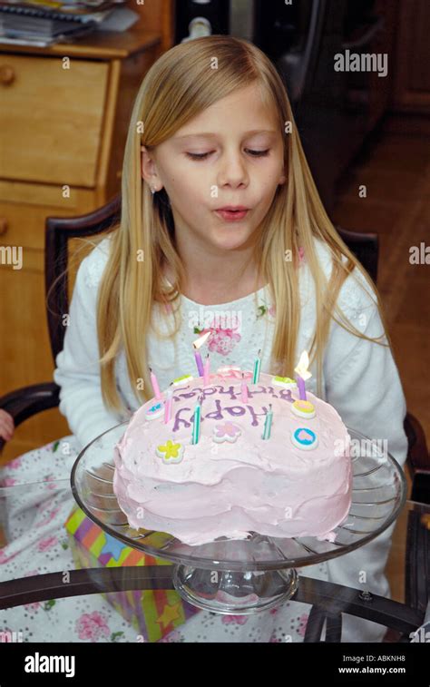 8 Year Old Girl Celebrates Her Birthday With A Cake With Candles Stock