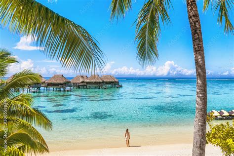 Luxury Tahiti Beach Resort Travel Tourist Walking On Polynesian Beach Ocean Water At Overwater