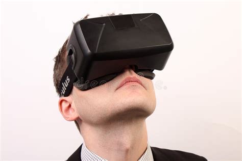 close up of a head of a man wearing a vr virtual reality oculus rift 3d headset looking upwards