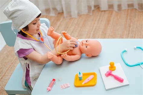 Premium Photo Little Girl Playing Doctor With Doll