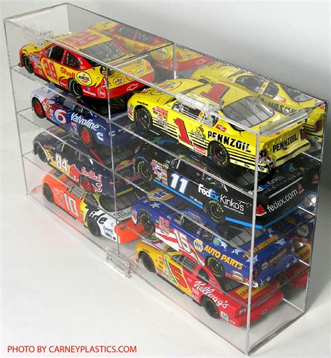 It held one 1/24 scale car on a small platform, and on each side of it there were two smaller platforms that would hold a 1/64 scale car. NASCAR Diecast Model Car Display Case 8 Car 1/24