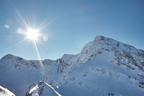 Bright Sun Shines On Snow Covered Mountains Stock Photo Image Of
