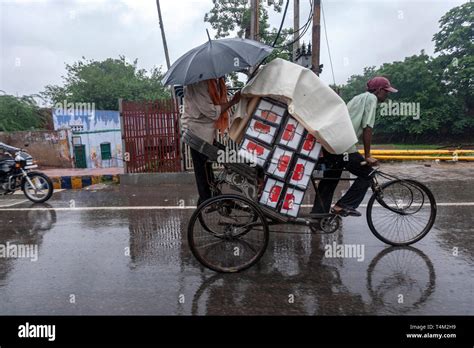 Indian Cycle Rickshaw Carrying Heavy Goods In A Rainy Day Uttar