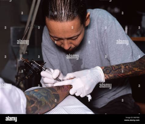 Japanese Tattoo Artist Working On Traditional Irezumi On Clients Arm