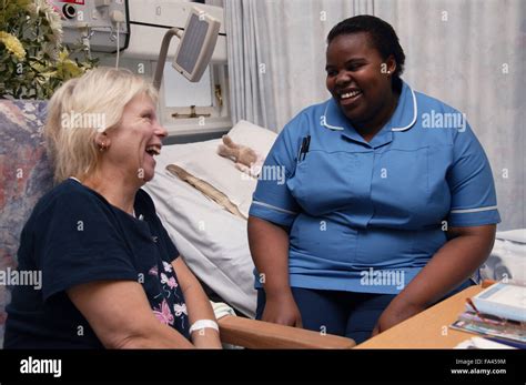 Cardiology Staff Nurse Chatting To Patient On The Ward Who Is Awaiting