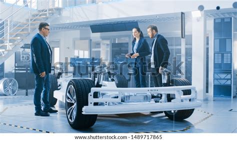 Automotive Design Engineers Talking While Working Stock Photo