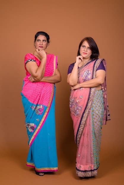 Premium Photo Two Mature Indian Women Wearing Sari Indian Traditional Clothes Together