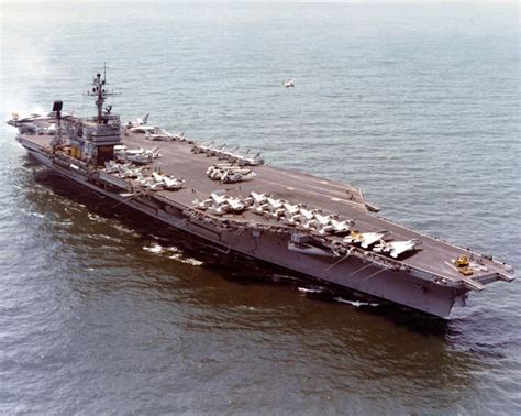 An Aircraft Carrier Floating On Top Of The Ocean