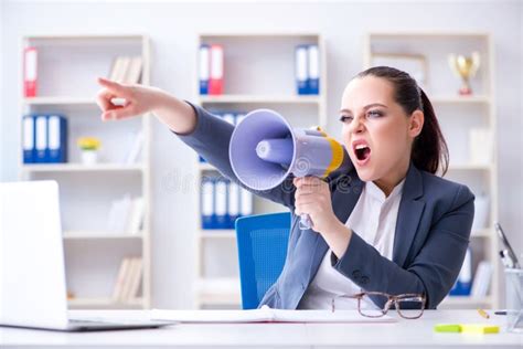 The Angry Businesswoman Yelling With Loudspeaker In Office Stock Image