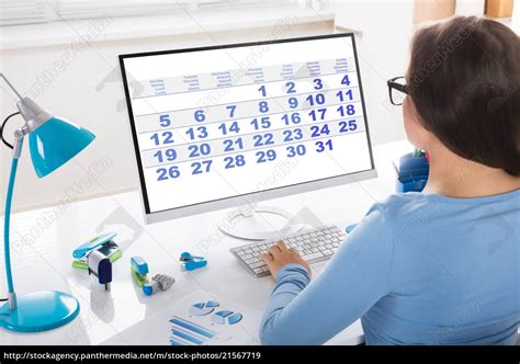 Businesswoman Looking At Calendar On Computer Stock Photo 21567719