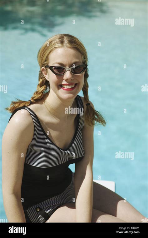 Young Woman Sitting On A Diving Board Stock Photo Alamy