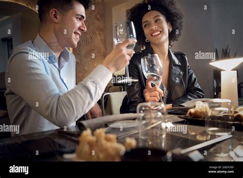 Happy Interracial Couple Having Fun Talking Eating And Drinking At