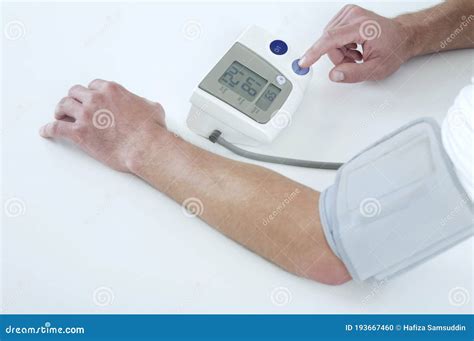 Man Having A Blood Pressure Examination Conceptual Image Shot Stock