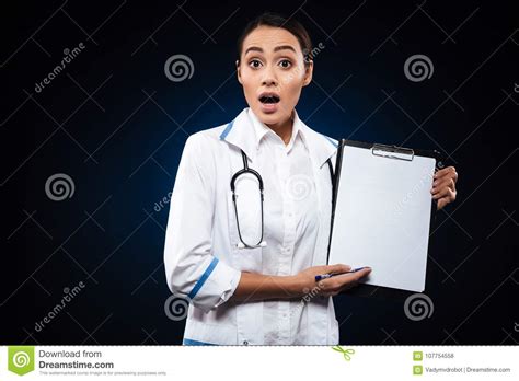 Shocked Lady Doctor In White Medical Gown Showing Blank Folder Isolated