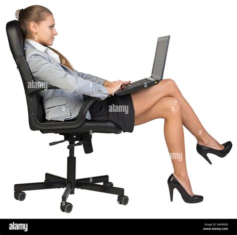 Businesswoman Sitting Back In Office Chair With Laptop On Her Knees