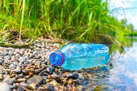 Environmental Pollution Plastic Bottles Littering A Riverbank Dump Mud