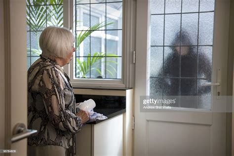 Stranger At The Door Worrying An Elderly Woman Photo Getty Images