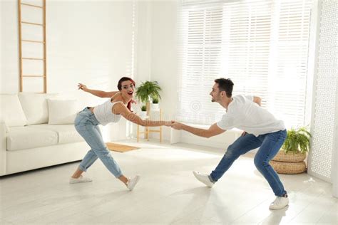 Beautiful Young Couple Dancing In Living Room Stock Photo Image Of