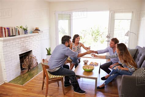 Couple Entertaining Friends At Home Stock Photo Dissolve