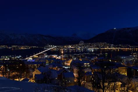 Tromso City At Winter Snowy Night With Lighttrafficfjord And Motion