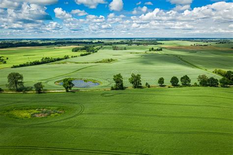 Stunning Green Field With Country Road In Sunny Day Stock Photo Image