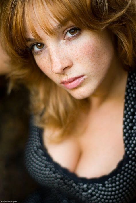 A Woman With Freckled Hair Posing For The Camera