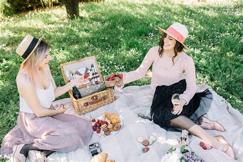 Two Female Friends Having Picnic In Nature By Stocksy Contributor