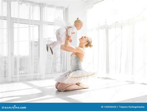 Mother In Ballet Outfit Holding On Hands Small Daughter Stock Photo