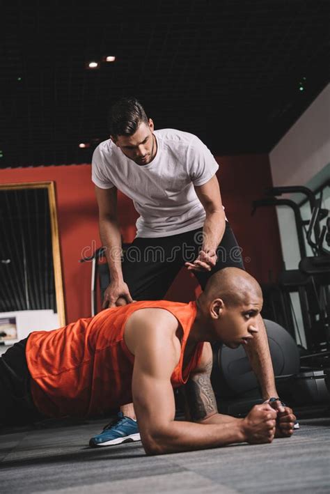 Attentive Trainer Supervising African American Sportsman Stock Photo