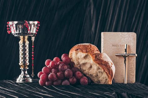 Bread Grapes Bible Chalice And Christian Crosses On Dark Table For