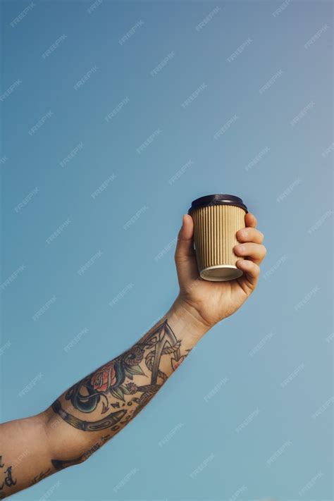 Free Photo Tattooed White Man Holds A Beige Disposable Coffee Cup