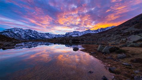Alpine Lake In Italian Alps Colorful Sky Sunset Snow Mountain Range