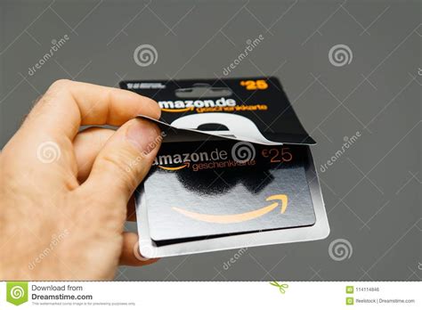 Amazon gift card 5 euro de. Man Holding Against Gray Background 25 Euros Amazon Gift Card Is Editorial Photo - Image of ...