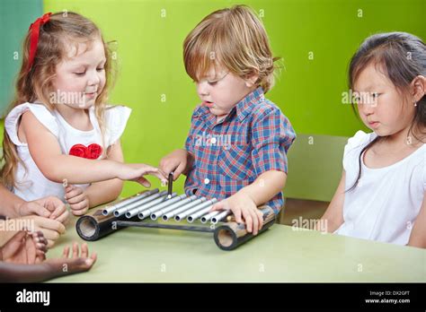 Boy Playing Xylophone In Kindergarten At Musical Education Stock Photo