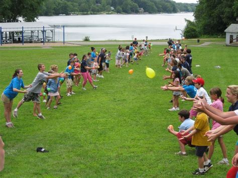 Summer Camp Enjoying A Game Of Water Balloon Toss Kid Fun Pinterest