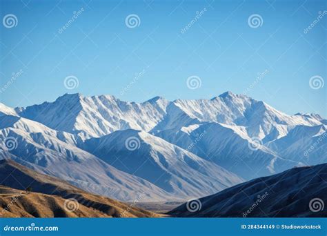 Majestic Mountain Range With Snow Capped Peaks And Clear Blue Skies