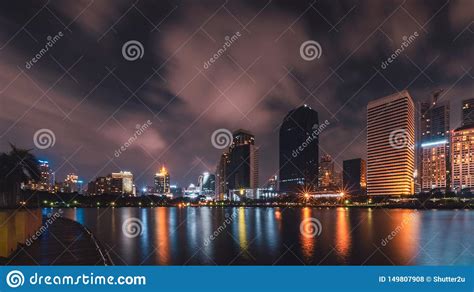 Big City In The Night Life With Reflection Of Water Wave Long Exposure