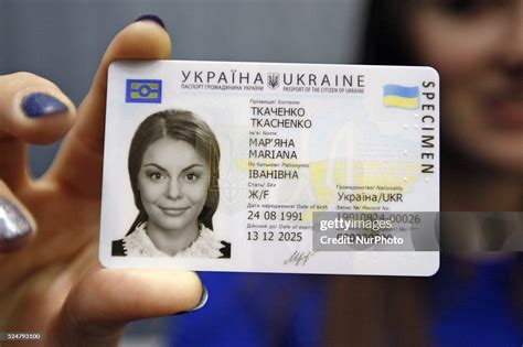 An Ukrainian Girl Holds In Her Hand A Specimen Of A New Id Passport