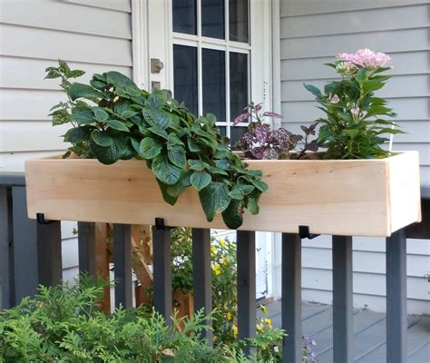 Planters can be suspended from your ceiling, railing and anywhere else to add some color. Cedar Railing Planter | Railing planters, Planters, Cedar ...