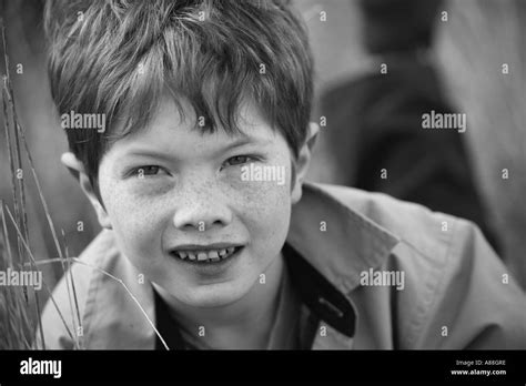 Horizontal Black And White Portrait Of Young Boy Playing Hide And Seek