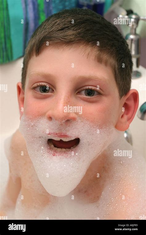 A Nine Year Old Boy Enjoying A Bubble Bath Stock Photo Alamy