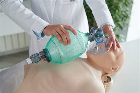 Woman Learning To Do Artificial Respiration On Mannequin Stock Image