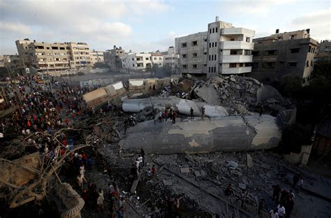 Standing beside a gaza road damaged in israeli air strikes, assad karam, 20, a construction worker. Gaza ceasefire ends flare-up, Palestinians resume protests