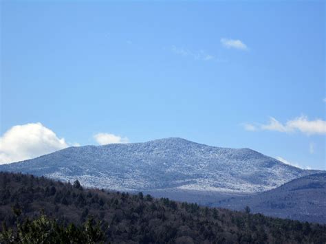 The Mountains Are Covered In Snow On A Sunny Day