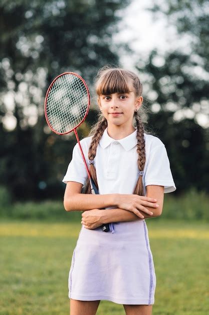 Free Photo Portrait Of A Girl Holding Badminton In The Park