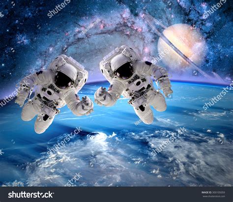 Two Astronauts Spaceman Outer Space Saturn Stock Photo