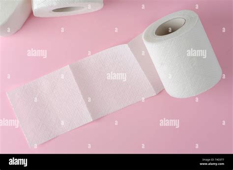 Single White Toilet Paper Roll On Pastel Pink Background Space For