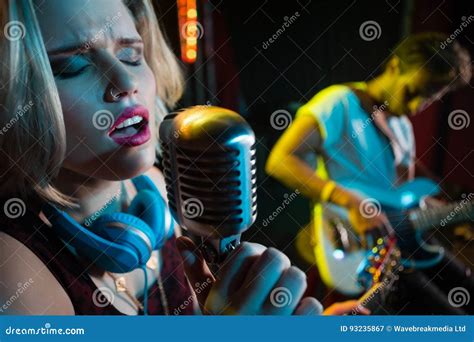 Female Singer Singing On Vintage Microphone Editorial Photography