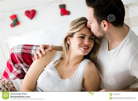 Portrait Of Young Loving Couple In Bedroom Stock Image - Image of relaxing, adult: 113787271