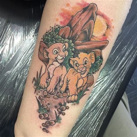 Delightful Tattoo With Little Simba And Nala On Background Of Mountain